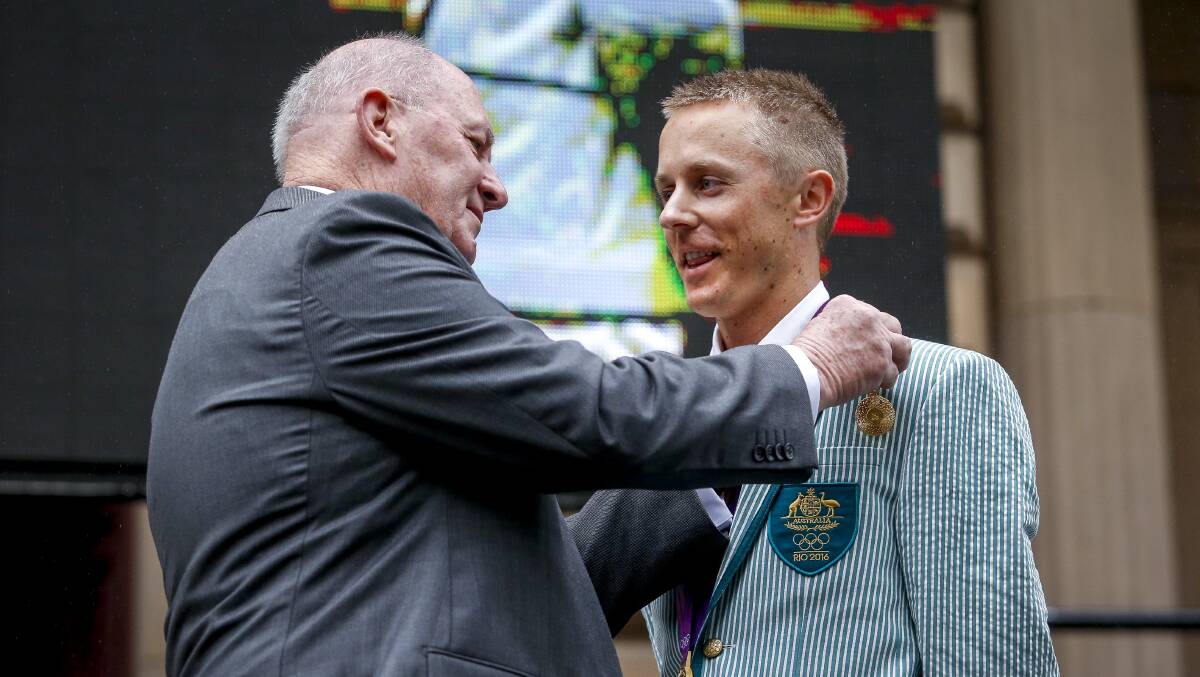 JUSTICE: Australian Governor-General Peter Cosgrove awards Jared Tallent the Olympic gold medal he rightfully earned four years earlier in London. Picture: The Age