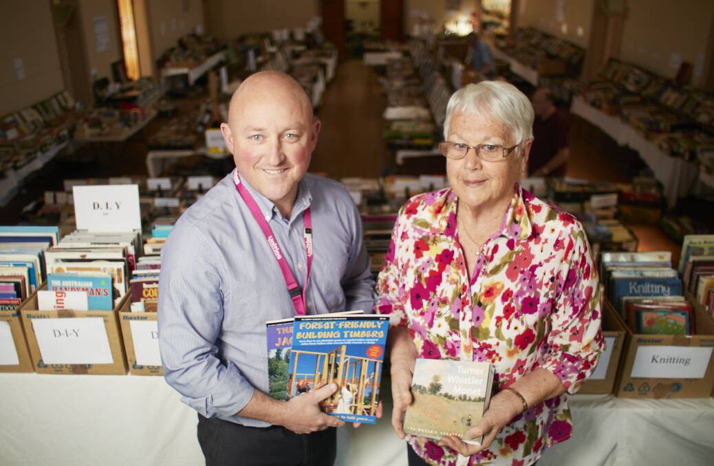 HELP: Uniting Ballarat chief Sean Duffy with long-time volunteer Anita Hinton at the popular biannual book fair, one of her many volunteer avenues put on hold during the pandemic.