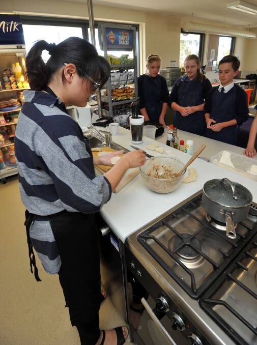 MASTERCLASS: Jing Tian teaches students the finer points of creating Chinese pork dumplings in Cuisines of the World at Ballarat Christian College. Picture: Lachlan Bence