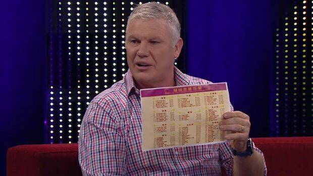 Bounce host Danny 'Spud' Frawley holding a Chinese menu while mocking the historic Shanghai AFL game. Photo: Fox Sports