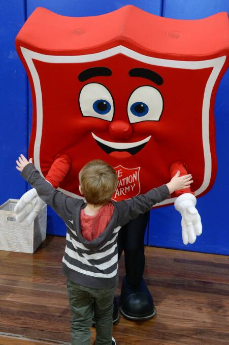 THANKS: Shieldy the Red Shield Appeal mascot greets support from Flynn Goode at the Delacombe Primary School assembly on Wednesday afternoon. Picture: Kate Healy