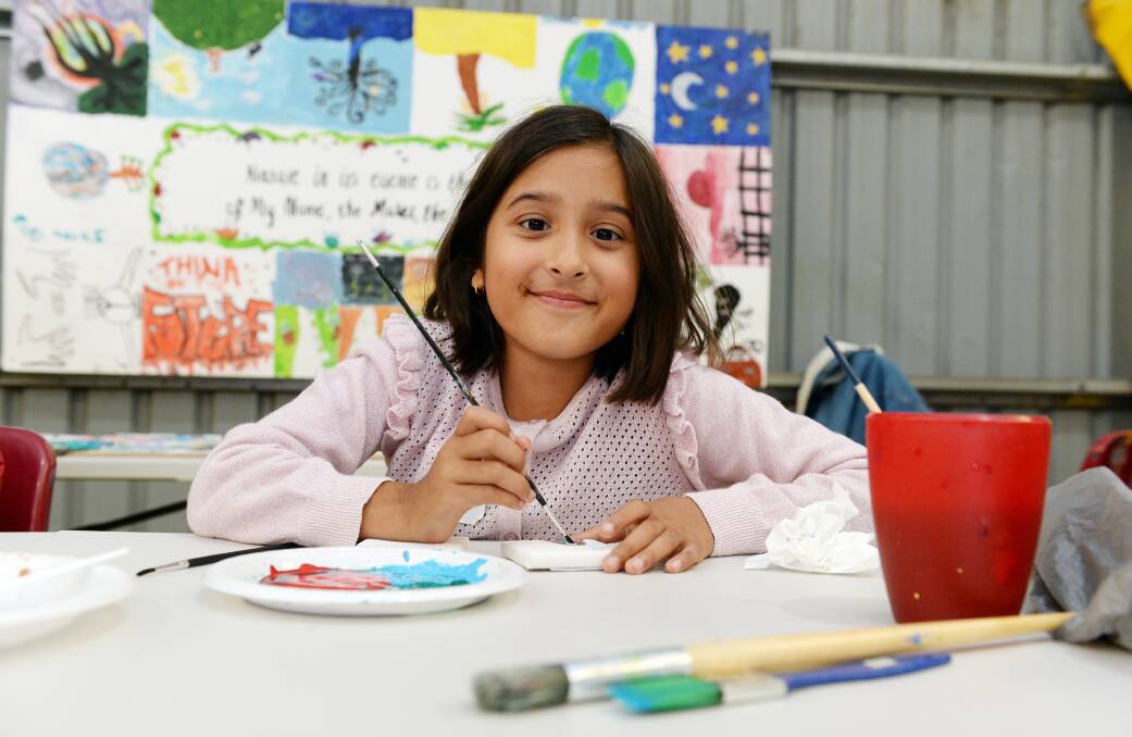 CELEBRATE: Lara, aged eight, enjoys painting for the festival. Picture: Kate Healy