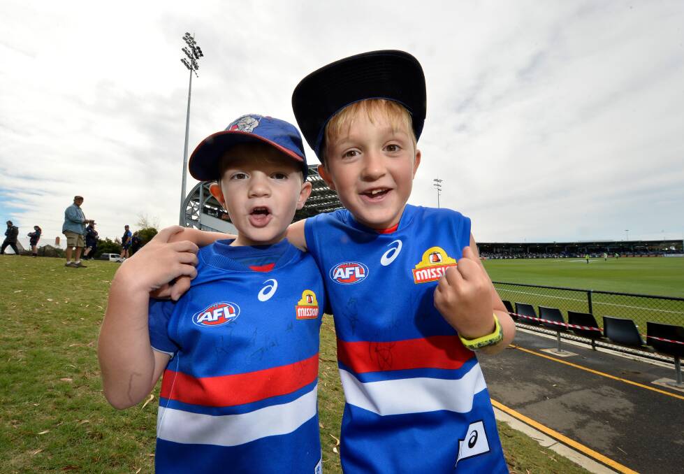 LOUD BARK: Young Western Bulldogs fans Jamison and Braxton get cheering for the club's AFL practice match against St Kilda at Mars Stadium in March. Picture: Adam Trafford.