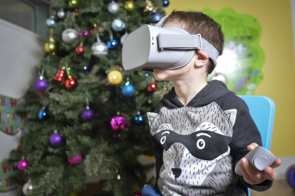 TOUR GUIDE: Four-year-old Riley Mason-Doyle takes a virtual, 360-degree look at the best Christmas lights in Ballarat from the hospital children's ward. Picture: Dylan Burns