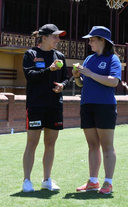 Mortlake's Georgia Wareham shares advice with a young Ballarat school cricketer during a Ballarat visit in late 2019, but there will be no Renegades action in town this season. Picture by Lachlan Bence