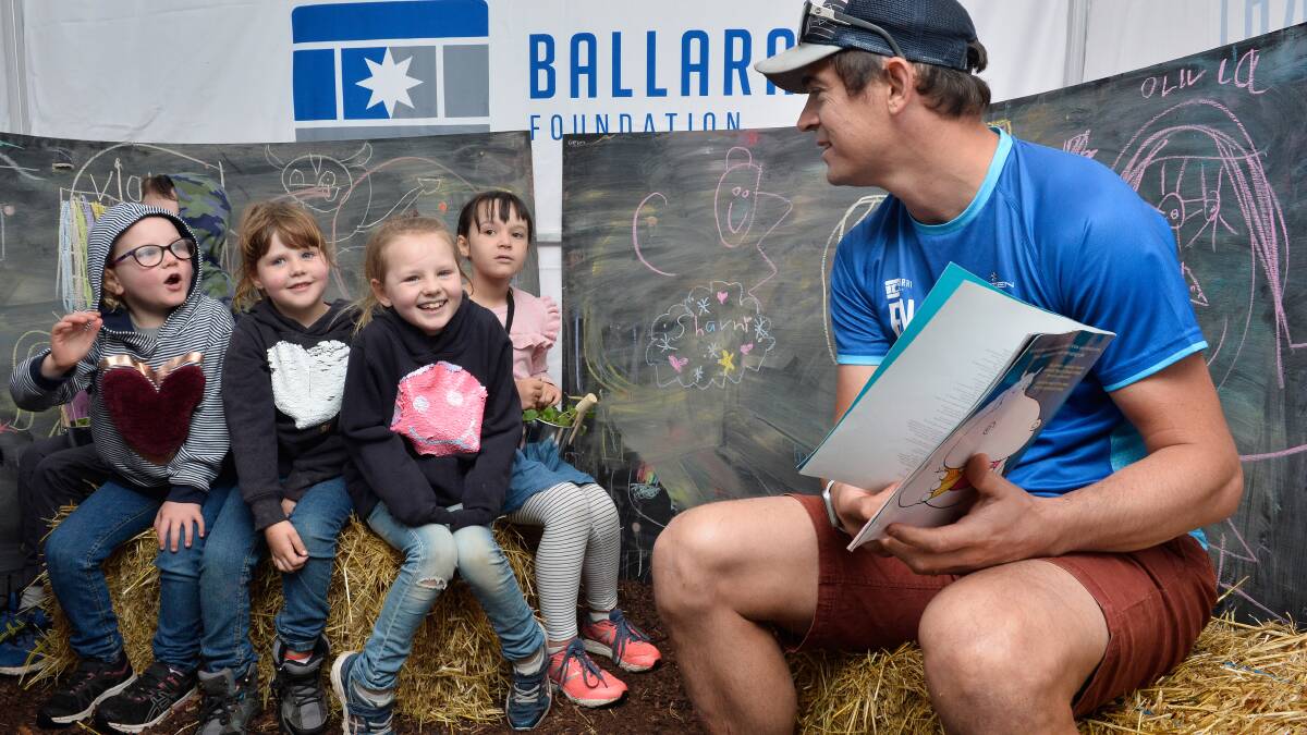 START: The Ballarat Foundation chief Matt Jenkins reads aloud to Corben, Isabella, Rosalie, Charlotte and Lexi in the Imagination Library for Begonia Festival. Picture: Adam Trafford