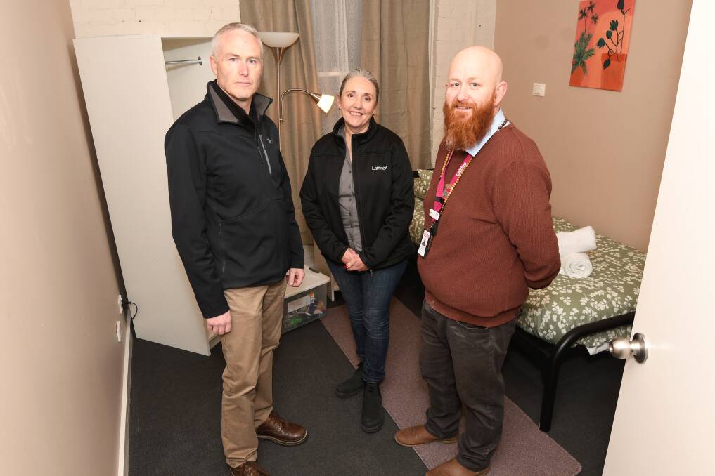 Federation TAFE's Damien Coats, Laminex manufacturing manager Tania Hancock and Uniting Ballarat Reid's Guest House manager Daniel Hemming inside the refurbished rooms. Picture by Lachlan Bence