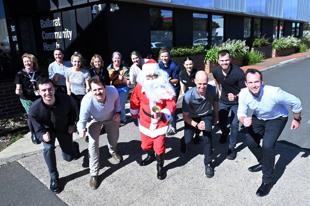 Ballarat Community Health's team warms up at the start line of Run For A Cause, with Santa. Picture by Kate Healy