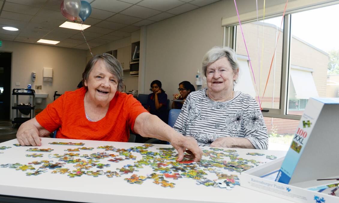 ACTIVE FUN: PS Hobson residents Joan Procter and Joy Boak team up to work on a puzzle in the new leisure hub, in which they can socialise more. Picture: Kate Healy
