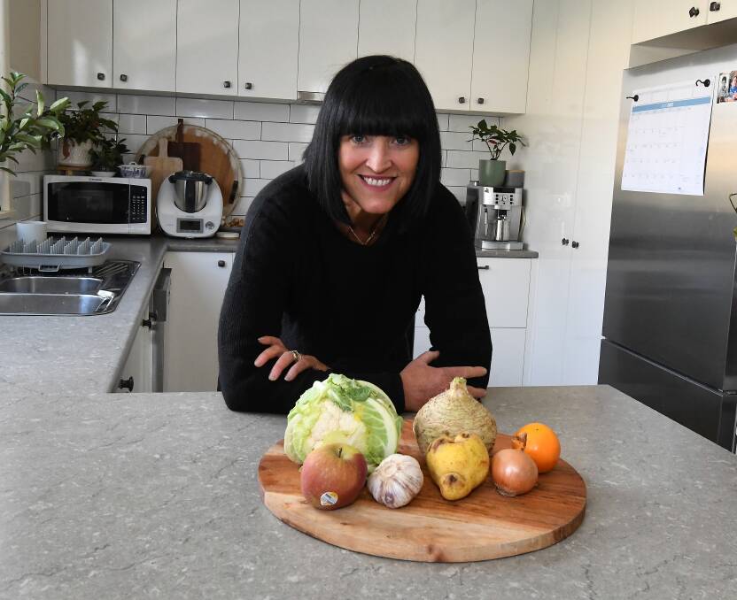 Ballarat's Julia Geue with a taster of her imperfect fruit and vegetables, including a small cabbage and celeriac and a wonky pear. Picture by Lachlan Bence
