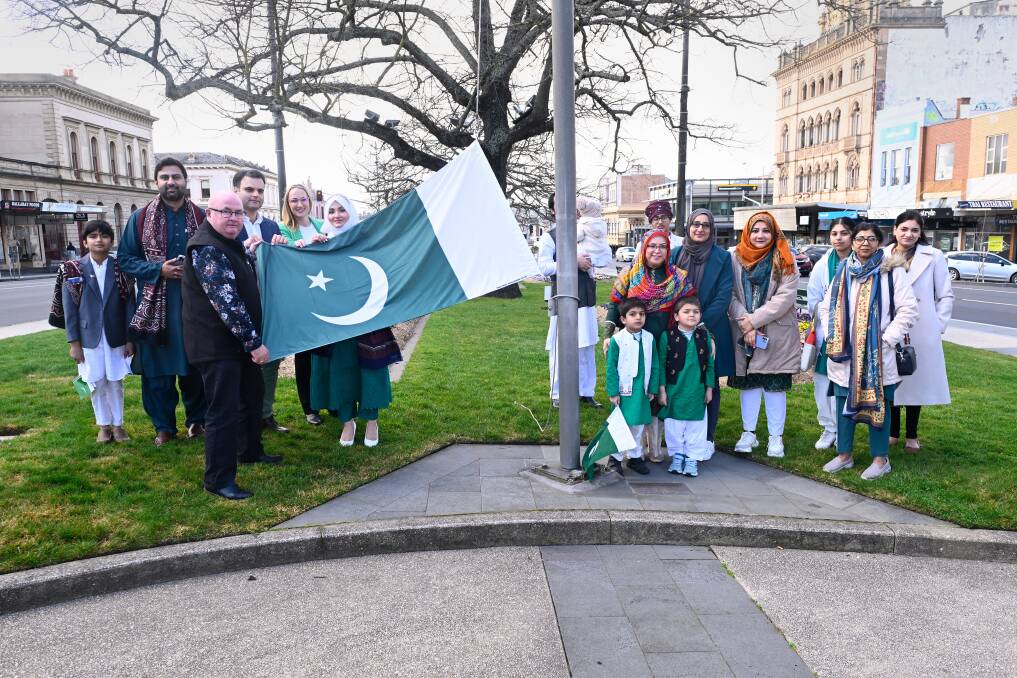 Members of Ballarat's Pakistani community gather to raise the national flag with City of Ballarat mayor Des Hudson on Pakistan Independence Day. Picture by Adam Trafford