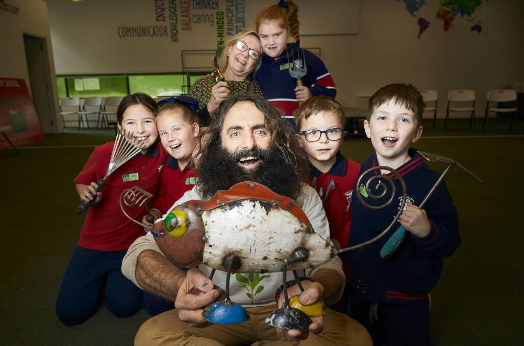 GREEN TEAM: Gardening Australia's Costa Georgiadis inspires Urquhart Park primary pupils to get composting. CLICK ON THE PHOTO TO READ MORE. Picture: Luka Kauzlaric