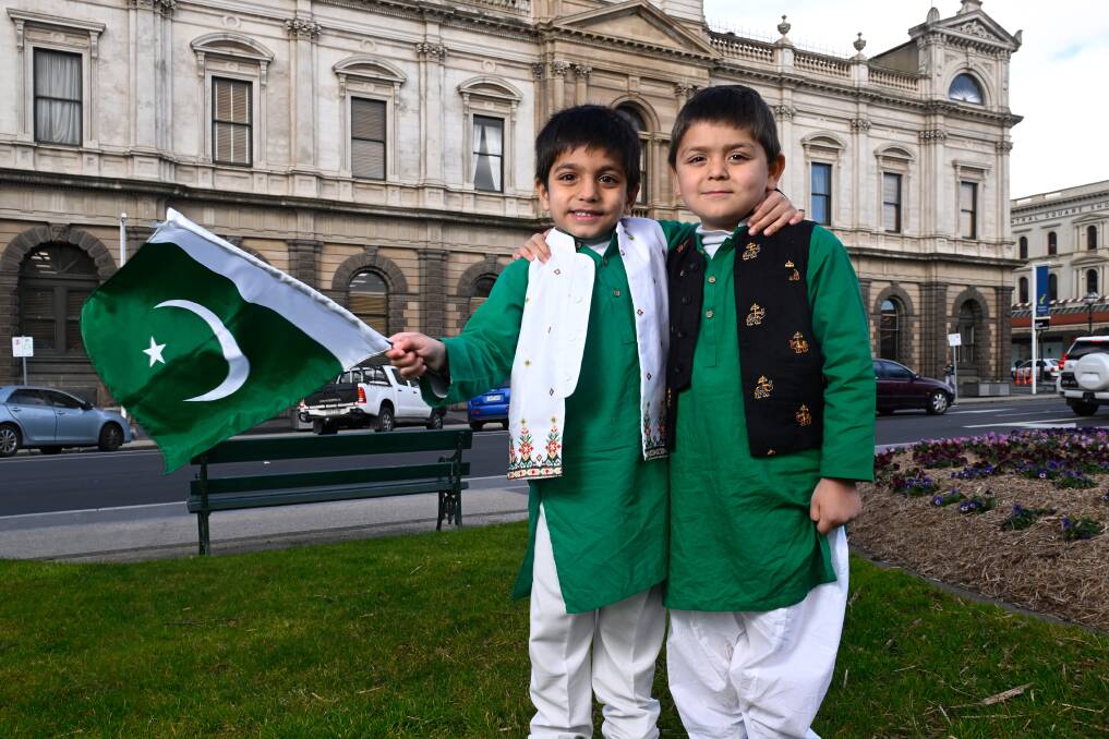 Rayayn and Shaheer proudly wave a Pakistani flag outside Ballarat Town Hall. Picture by Adam Trafford