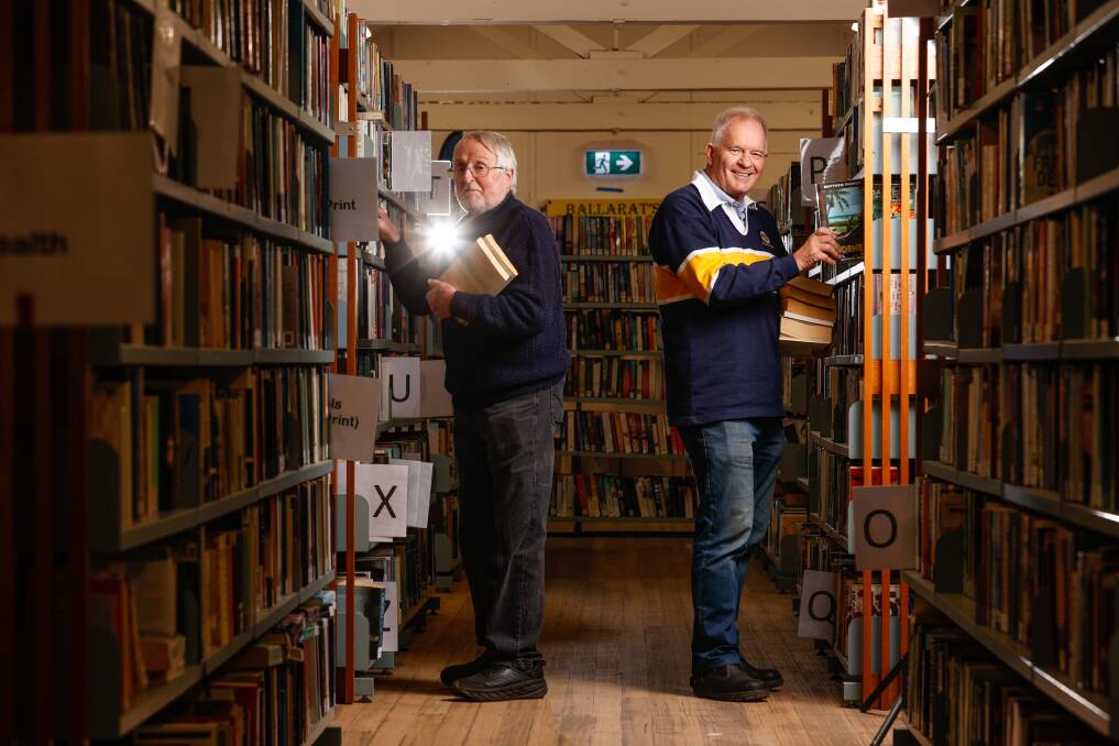 Shelving great book ideas is Rotary Club of Ballarat East's David Stokes and Phil Mann ahead of another bumper fair this weekend. Picture by Luke Hemer