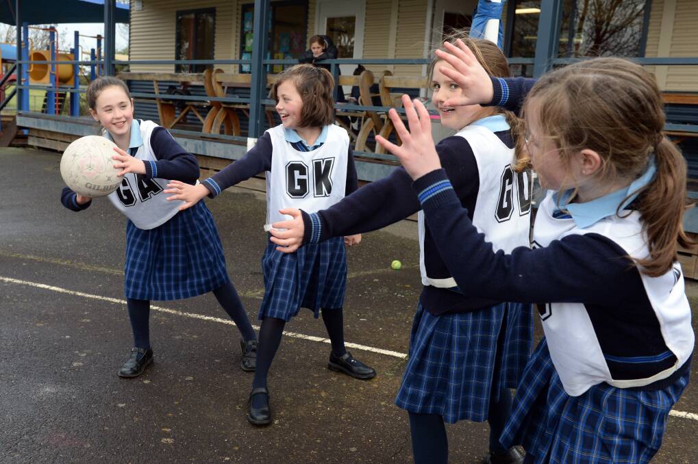ACTION: St Brendan's netballers Emma, Bonnie, Sienna and Sophie can hardly wait to have rival teams to play against once more in Ballarat Netball Associations primary school competition - hopefully from next term. Picture: Kate Healy