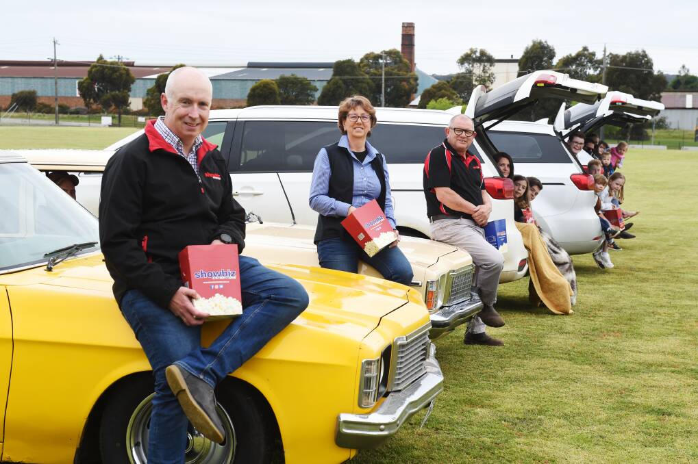 Chris Jones Showbiz director), Elizabeth van Beek (Ballarat Agricultural and Pastoral Society executive officer), John Bourke (Showbiz operations manager) with families that are ready for the drive-in. Picture: Kate Healy
