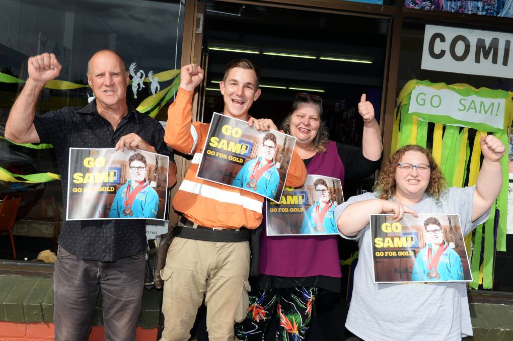 ROARING: Allan Fletcher, James De Rose, Heroes HQ owner Jeannine le Vaillant and shop worker Ruby Le Vaillant have been cheering loud for Sam Rizzo on his Commonwealth Games mission. Picture: Kate Healy