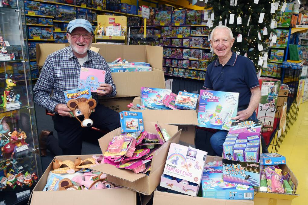 TOY SURPRISE: St Vincent de Paul regional manager Alan West and 3BA Christmas Appeal ambassador Peter Caligari feel joy for the toys already starting to appear under the Toyworld tree. Picture: Kate Healy