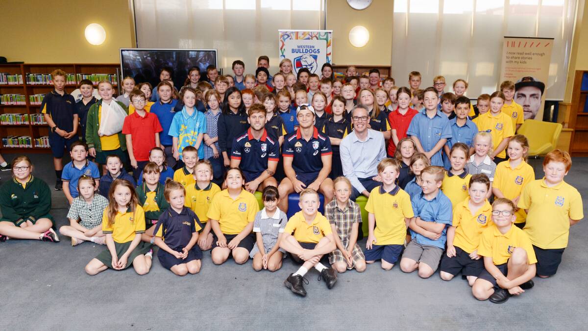 BEGINNING: Pupils ready to get started in Bulldogs Read with Western Bulldogs AFL players Riley Garcia and Caleb Daniel and City of Ballarat mayor Ben Taylor. Picture: Kate Healy