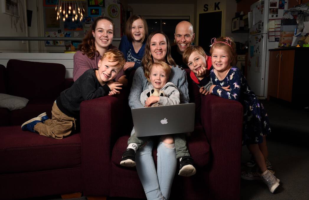 WORKING TOGETHER: Kristin and Sam Harmer are ready to start classes from home with children Banjo, Lily, Winter, Felix, Beau and Violet. Picture: Adam Trafford