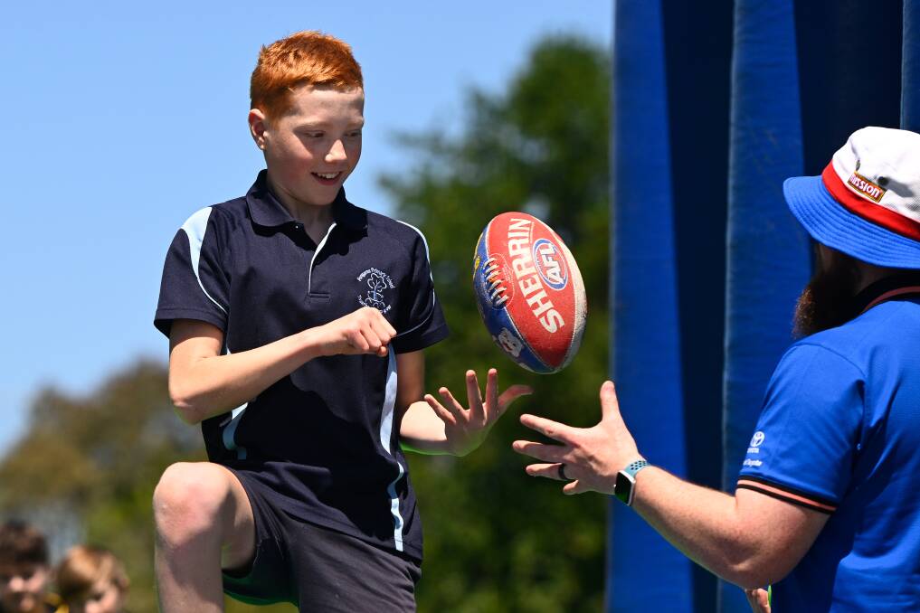 Bungaree primary pupil James gets into handball action in a Western Bulldogs community clinic in October, 2023. Picture by Adam Trafford