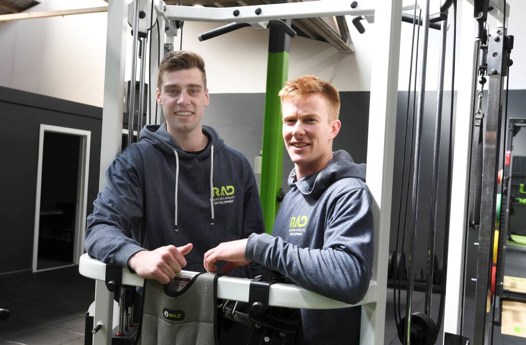 FOCUS: Strength and conditioning coach Chris Radford (right) with Tim Welsh, in the new purpose-built gym for Ballarat athletes to fine-tune their games. Picture: Lachlan Bence