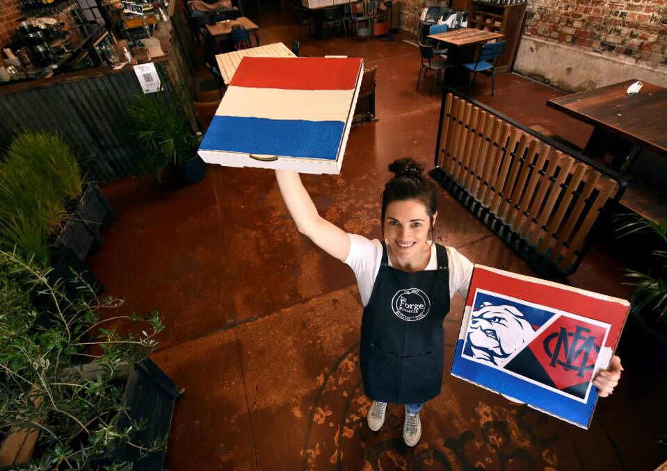 DOGGIE BAG: The Forge's Stacey Matthews shows the pizzeria is getting into the foodie spirit to support Ballarat's home team Western Bulldogs for the AFL Grand Final. Picture: Jeremy Bannister