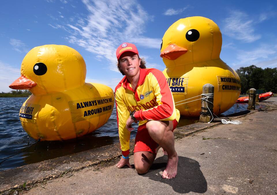 WATCH: A big duck keeps a close watch on the little duck on Lake Wendouree to encourage water safety with lifeguard Harrry Gleeson this summer. Picture: Adam Trafford