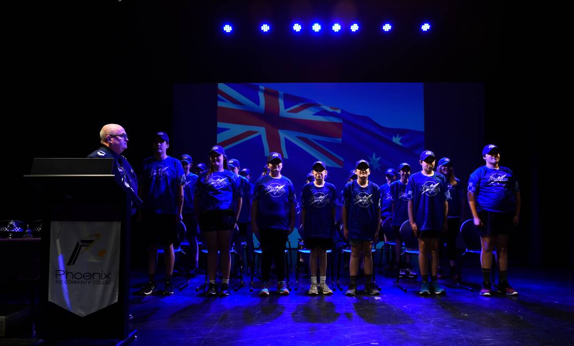 DISCIPLINE: Ballarat Leading Senior Constable Des Hudson leads students in the national anthem to open their graduation ceremony. Picture: Adam Trafford.