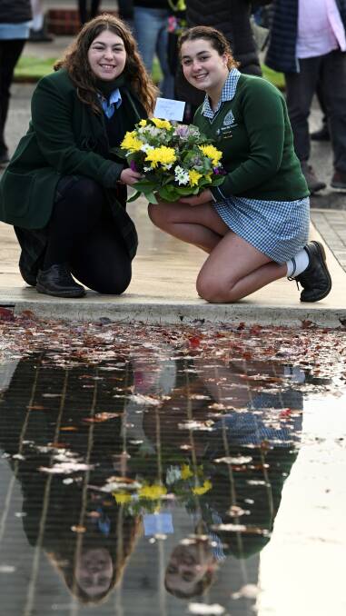 Ballarat High School students and sisters Naomi and Leah Ross say it is an honour to be in class to the arch every day. They joined schoolmates in laying at wreath at the Arch of Victory on Anzac Day 2024. Picture by Lachlan Bence