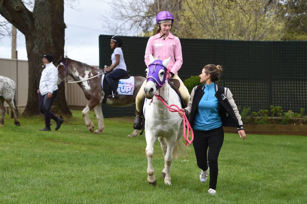 LEADING EXAMPLE: Michelle Payne offers advice to Mercedes Hobson, age 12, who is riding Harriet in the Ballarat Saddle Up session on Tuesday. Picture: Kate Healy