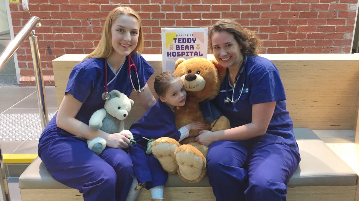 LEARNING SESSION: Ballarat medical students Evelyn Andrews and Mieke Foster meet qualified teddy doctor Alex, age three, in hospital.