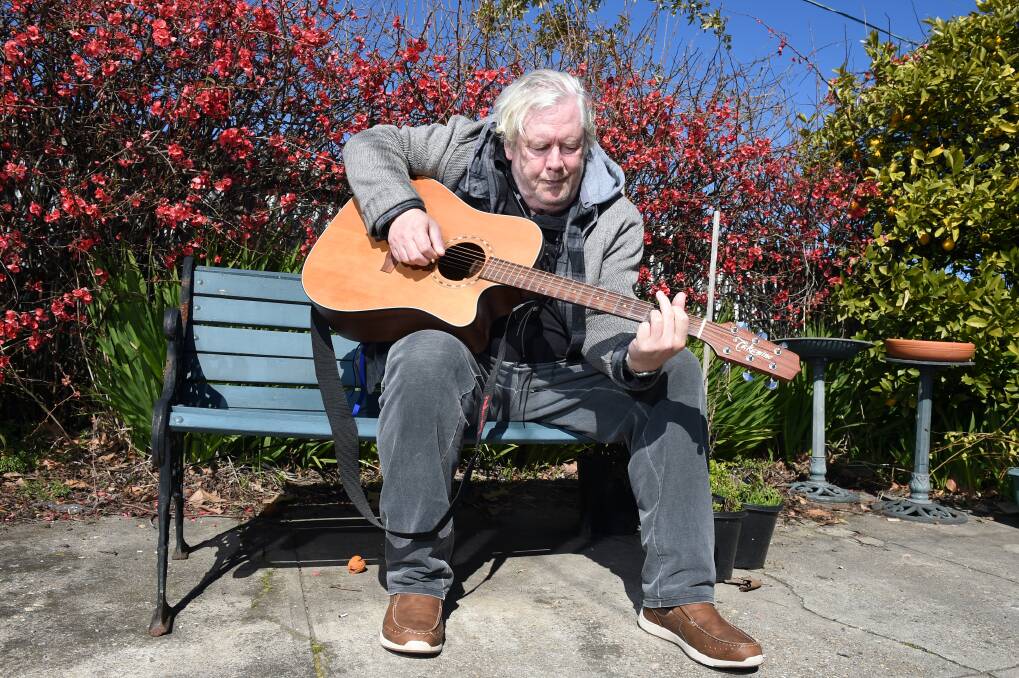EXPRESSIVE: Mark Leishman finds his chance to plays guitar in Wild at Heart Community Arts for people with lived experience of mental illness. Picture: Kate Healy
