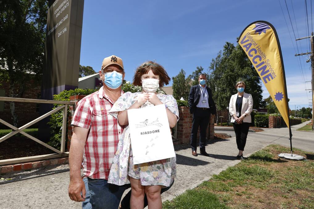 PROTECT: Stuart Nimmo and his daughter Aubrey along with Craig Wilding and Lisa Oro of BHS after the 7-year-old received her first COVID-19 vaccination in early January. Picture: Luke Hemer 