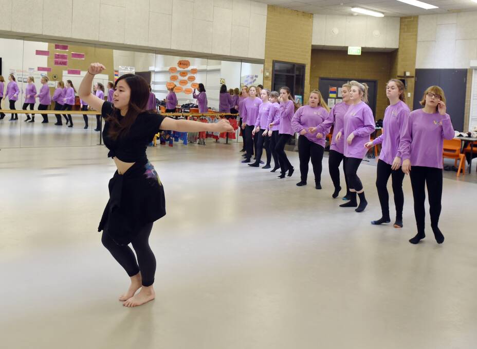 OUT FRONT: Sayaka Miyajima practises with members of the dance troupe from Mount Clear College, preparing for the Victorian State Schools Spectacular. Picture: Kate Healy