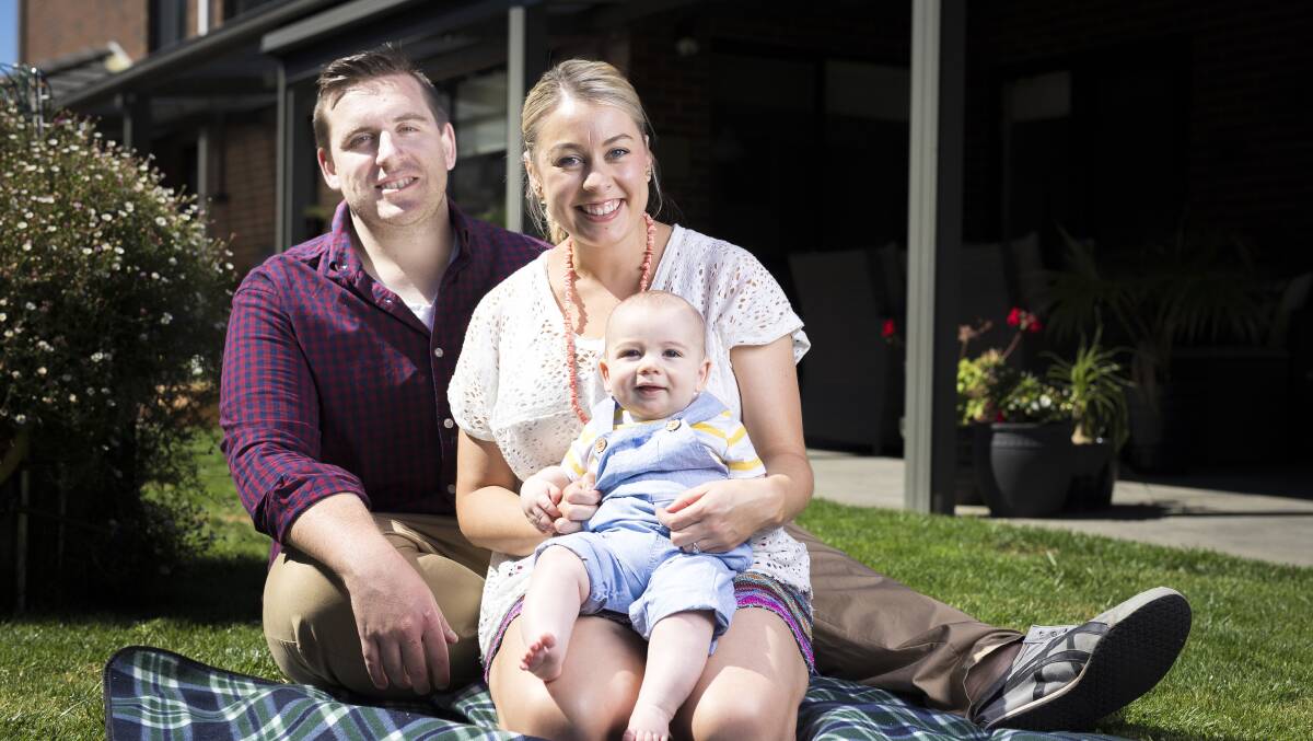 Cover baby Harrison Eric Marks with his parents Sam and Luke.
