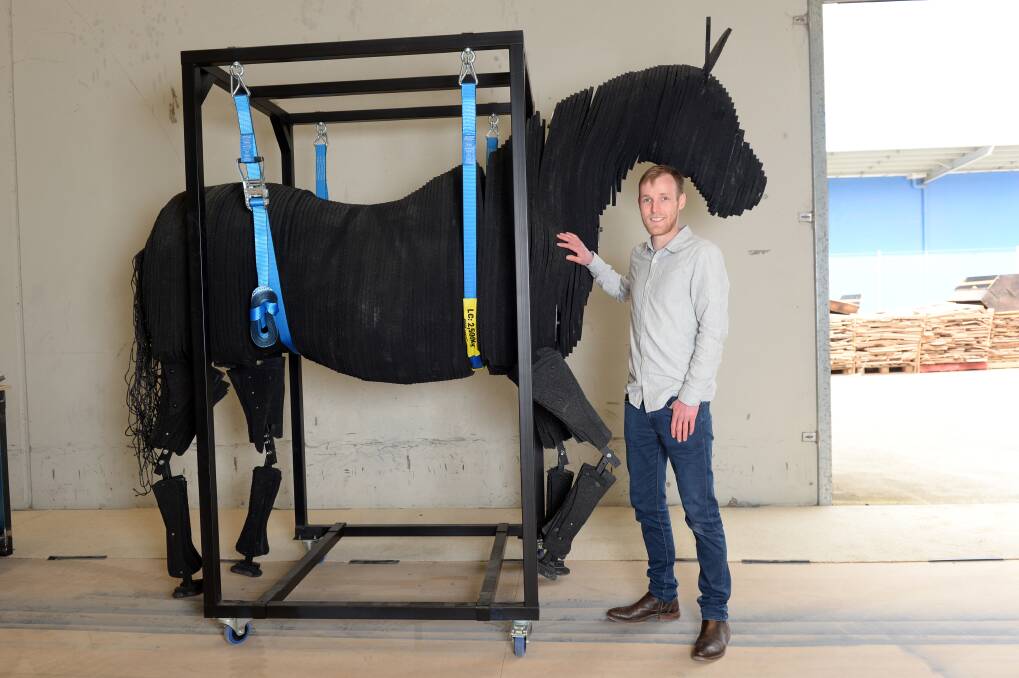 Areion Equestrian founder Tom Hotchkin with the crash-test dummy horse developed by the Ballarat-based company to test their crash-safe horse float. Photos: Kate Healy. 