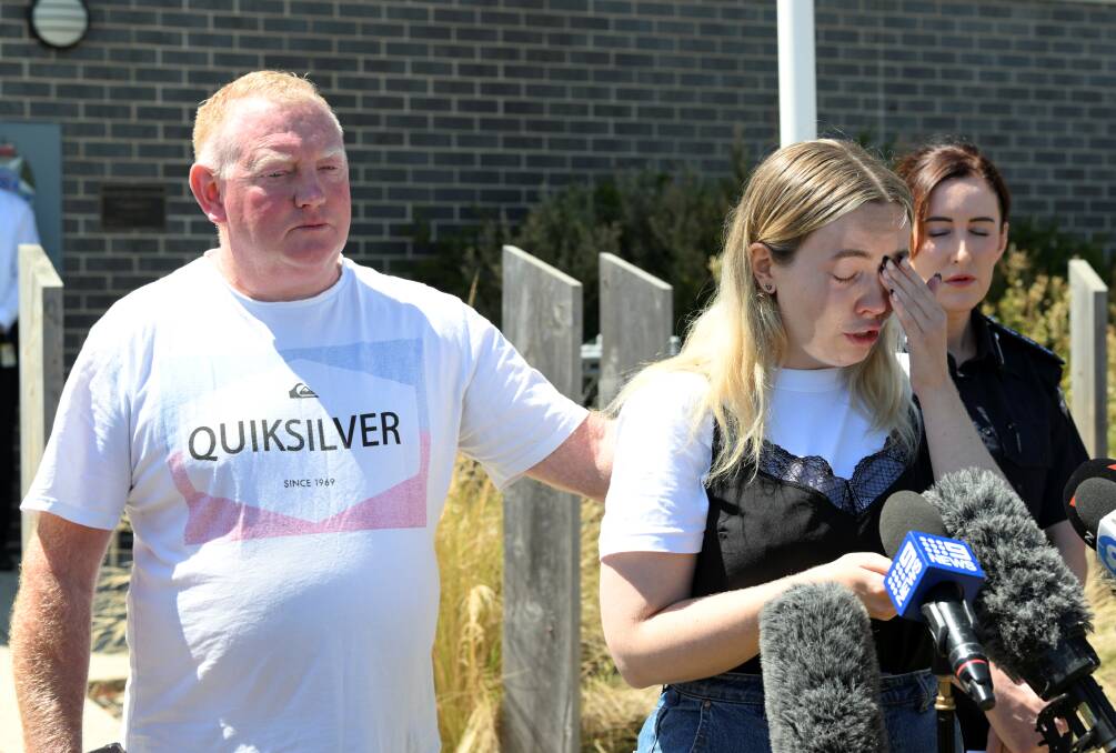Mick Murphy comforts his daughter Jess while speaking to the media. Picture by Lachlan Bence
