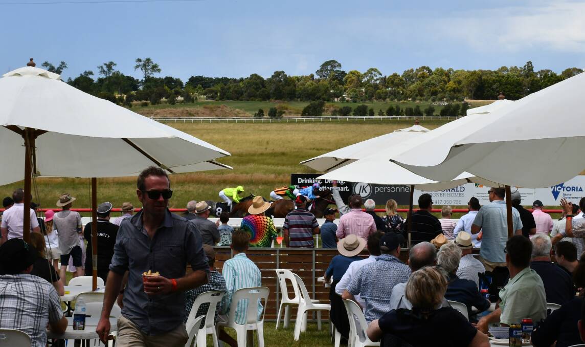 A socially distanced crowd cheers on runners on Burrumbeet Cup day. Pictures: The Courier