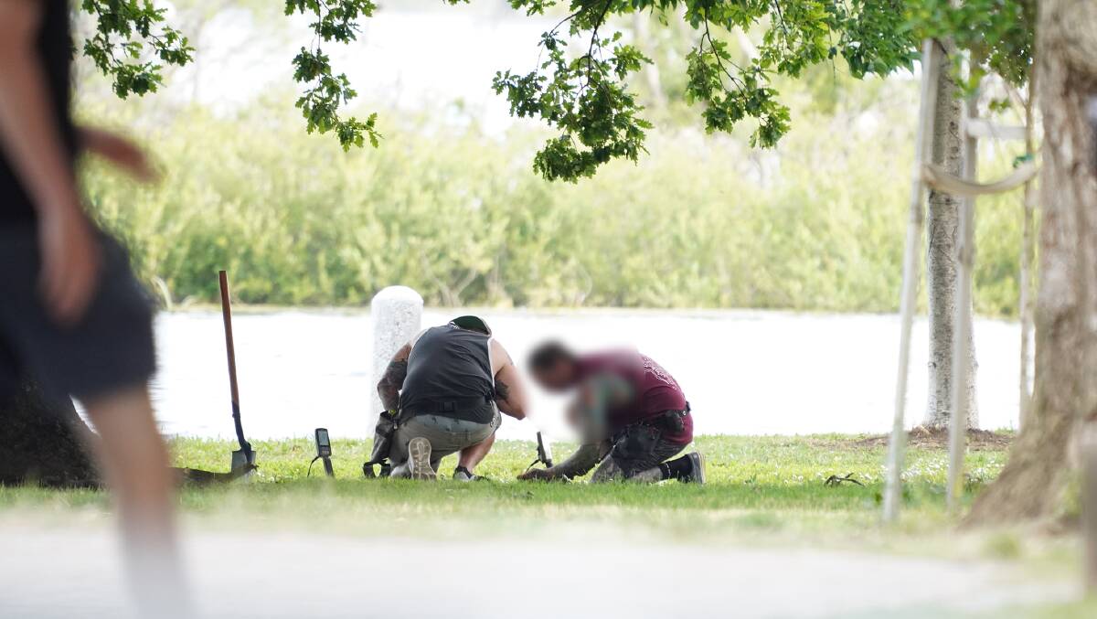 Move on: A witness snapped a photo of two men digging in Lake Wendouree's gardens. Picture: contributed