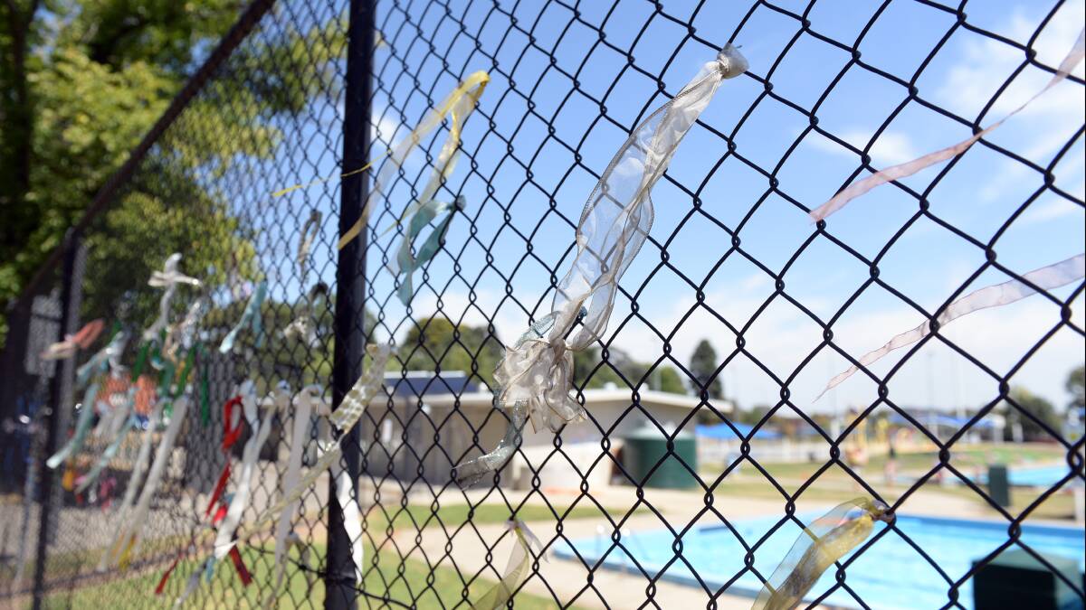 Memory: Ribbons on the Eureka Swimming Pool fence on Thursday. Picture: Kate Healy