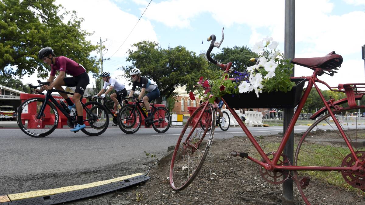 Cyclists head past one of the Buninyong Red Bikes. Picture: Lachlan Bence