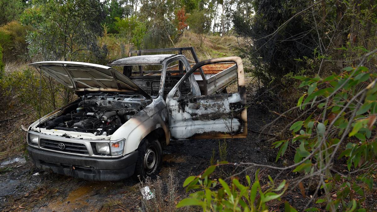 Burnt out: The car on the cemetery grounds. Picture: Adam Trafford