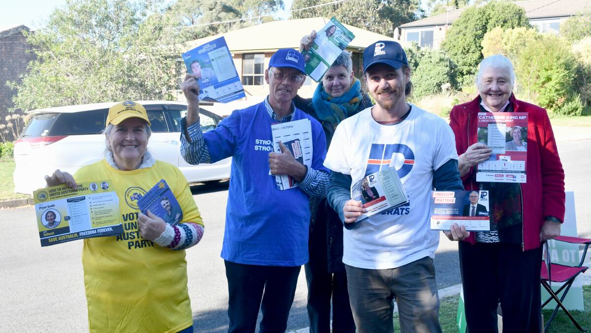Working together. Volunteers from across the political spectrum hand out flyers at Mount Pleasant Primary School on election day. Picture: The Courier
