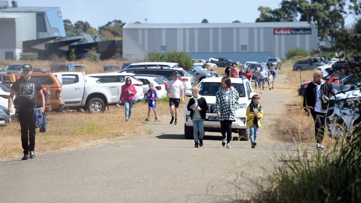 People walk towards Eureka Stadium from the former John Valves site on Norman Street on March 24. Picture by Kate Healy