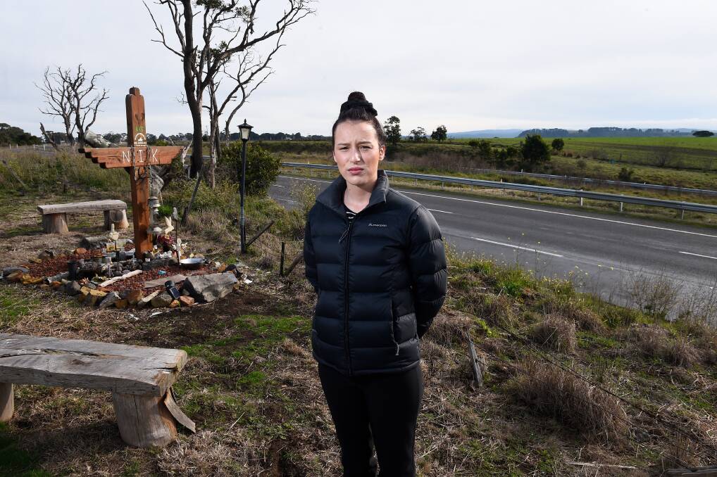 Nik Barbara's sister Tori at the shrine near where he died after a collision on the Western Freeway in 2016. Picture: Adam Trafford