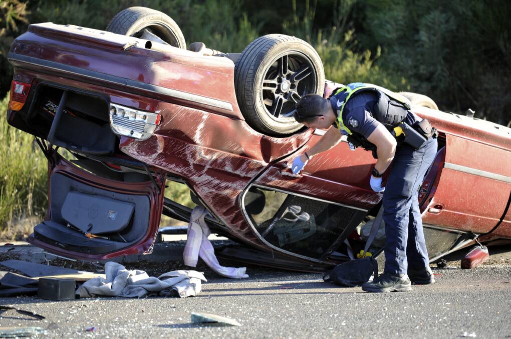 Police inspect the vehicle after the crash. Pictures: Lachlan Bence