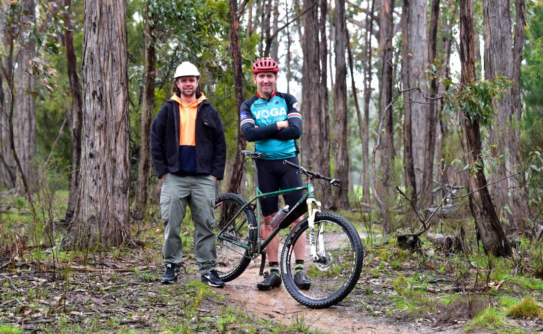 Momentum: Hepburn Shire's Creswick Trails Project construction manager Mick McCallum and rider Dr Mick Veal in bushland near Creswick. Picture: Brendan McCarthy