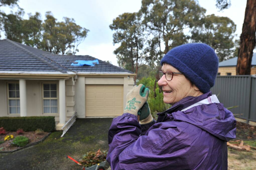 Helen McDowell cleans up in front of her Buninyong home. Pictures: Lachlan Bence