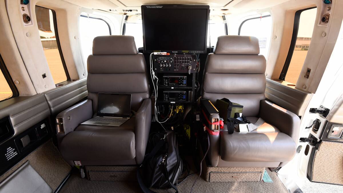 The set-up inside the helicopter - note the large screens and equipment to transmit the live feed to other helicopters and the control centre.